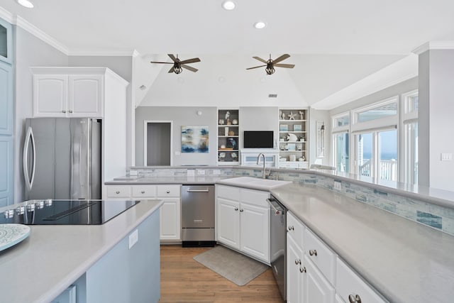19307 Shores Dr, Galveston, TX 77554 - kitchen featuring sink, crown molding, stainless steel appliances, hardwood / wood-style floors, and white cabinets