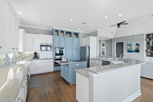 19307 Shores Dr, Galveston, TX 77554 - kitchen featuring a kitchen island, white cabinets, and appliances with stainless steel finishes