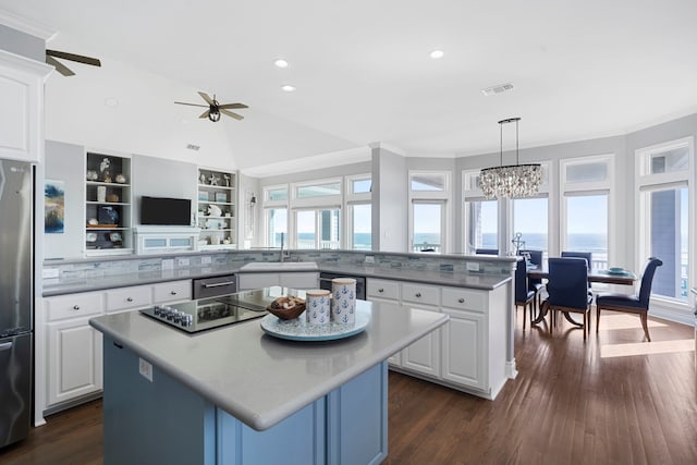 19307 Shores Dr, Galveston, TX 77554 - kitchen featuring white cabinetry, decorative light fixtures, and a kitchen island