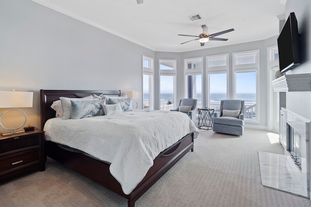 19307 Shores Dr, Galveston, TX 77554 - carpeted bedroom featuring ornamental molding, access to exterior, and ceiling fan