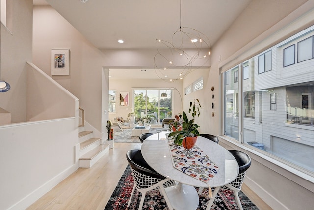 dining area featuring a chandelier and light hardwood / wood-style flooring