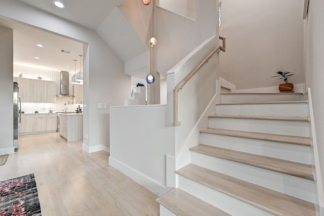 stairway with hardwood / wood-style floors