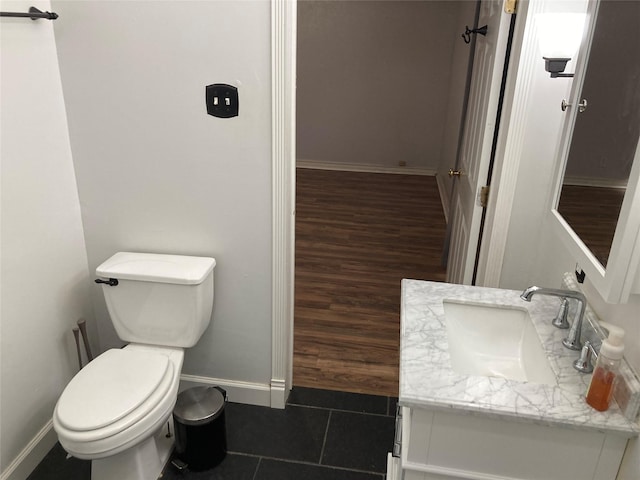 bathroom with tile patterned flooring, vanity, and toilet