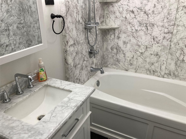 bathroom featuring vanity and tiled shower / bath