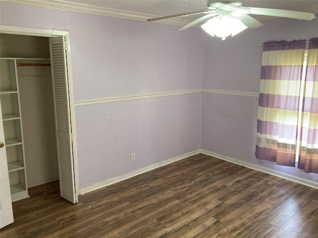 unfurnished bedroom with ceiling fan, ornamental molding, dark hardwood / wood-style floors, and a closet