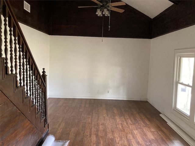 unfurnished room featuring lofted ceiling, dark wood-type flooring, and ceiling fan