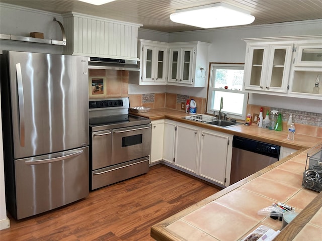 kitchen with stainless steel appliances, tile counters, sink, and white cabinets