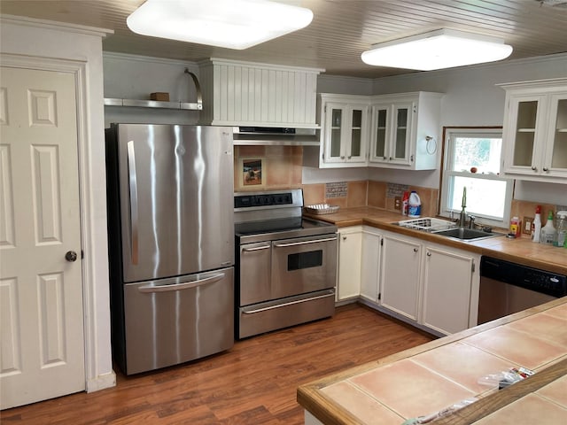 kitchen featuring white cabinetry, sink, tile counters, and appliances with stainless steel finishes