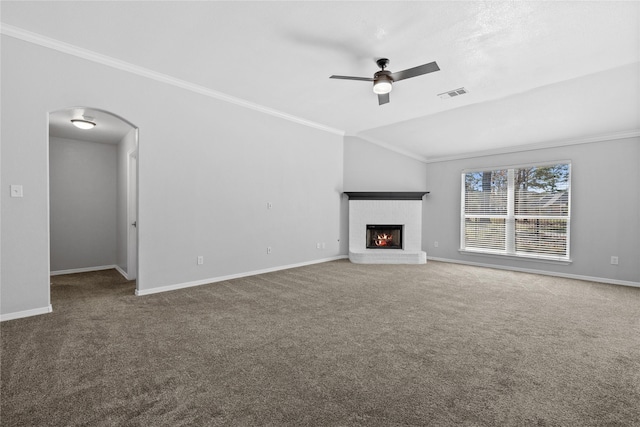 unfurnished living room with arched walkways, visible vents, ornamental molding, a brick fireplace, and carpet