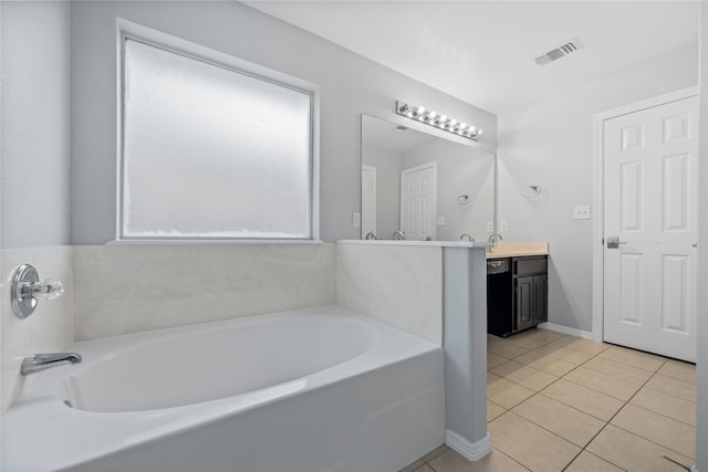 bathroom with visible vents, baseboards, a garden tub, tile patterned flooring, and vanity