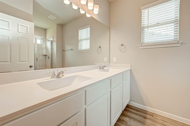 bathroom with vanity, hardwood / wood-style floors, and walk in shower