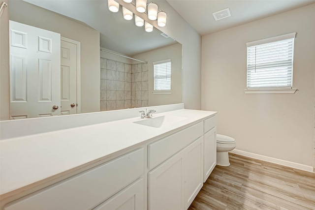 bathroom featuring hardwood / wood-style flooring, vanity, and toilet