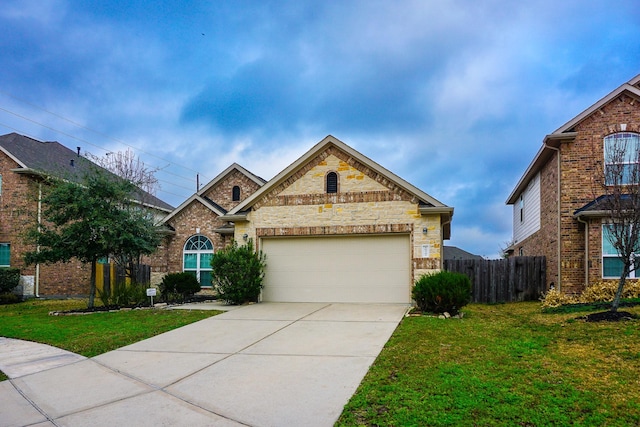 view of front of house featuring a garage and a front lawn