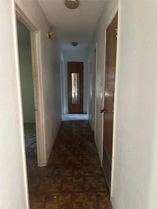 corridor featuring dark parquet flooring