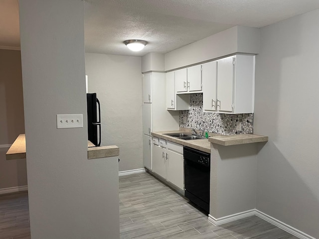 kitchen featuring white cabinetry, backsplash, black appliances, and light hardwood / wood-style floors