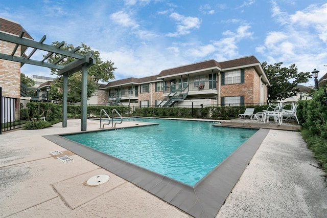 view of swimming pool with a pergola and a patio