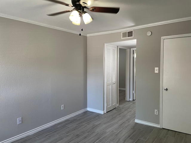 unfurnished bedroom featuring ceiling fan and ornamental molding