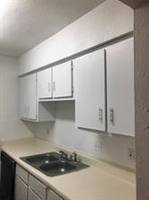 5625 Antoine Dr Unit 1309, Houston, TX 77091 - kitchen with white cabinetry and sink