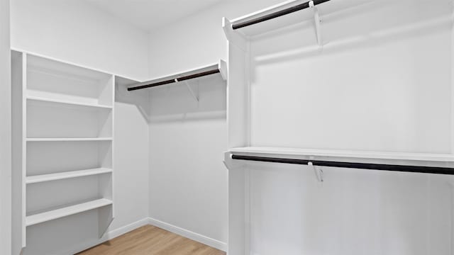 walk in closet featuring light wood finished floors