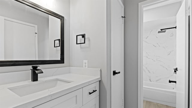 bathroom featuring vanity and shower / bathtub combination