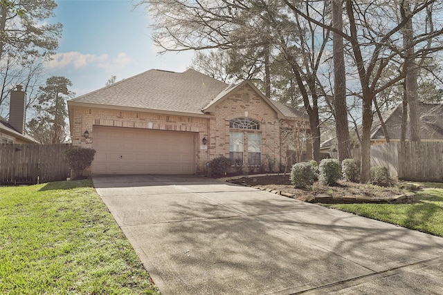 view of front of property featuring a garage and a front yard