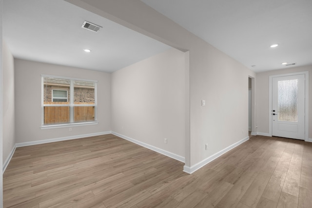 unfurnished room with recessed lighting, visible vents, light wood-style flooring, and baseboards