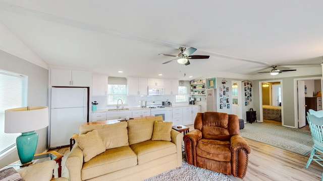 29331 County Rd 25, Damon, TX 77430 - living room featuring sink, ceiling fan, and light wood-type flooring