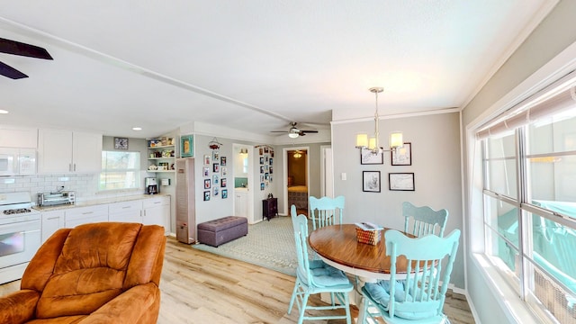 29331 County Rd 25, Damon, TX 77430 - dining area featuring ceiling fan with notable chandelier and light hardwood / wood-style floors