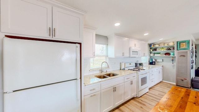29331 County Rd 25, Damon, TX 77430 - kitchen featuring sink, white cabinets, and white appliances