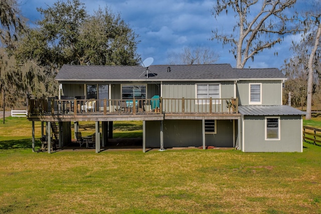 back of house with a deck and a lawn