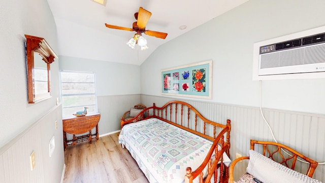 29331 County Rd 25, Damon, TX 77430 - bedroom with vaulted ceiling, an AC wall unit, ceiling fan, and light wood-type flooring