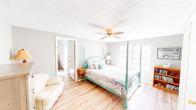 29331 County Rd 25, Damon, TX 77430 - bedroom featuring ceiling fan, wood-type flooring, and a textured ceiling
