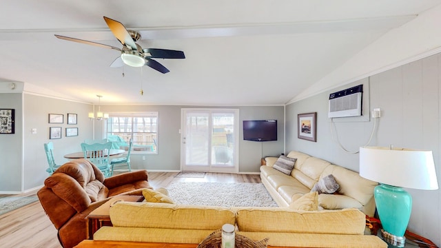 29331 County Rd 25, Damon, TX 77430 - living room with lofted ceiling, a wall mounted air conditioner, ceiling fan with notable chandelier, and light hardwood / wood-style flooring