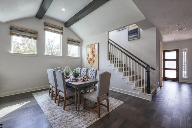 dining room with dark wood-type flooring, plenty of natural light, and vaulted ceiling with beams