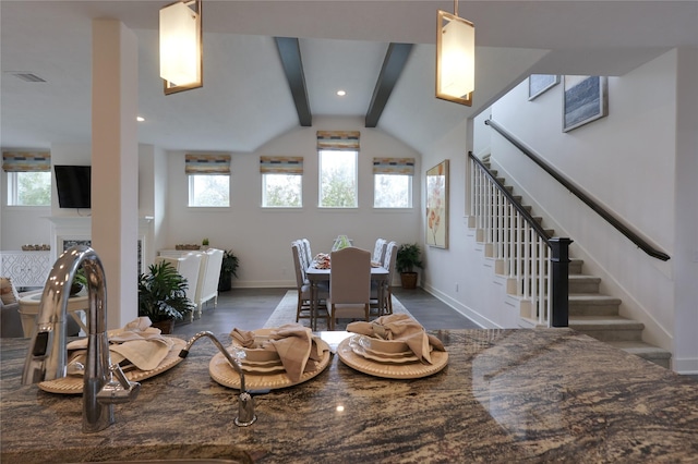 dining room featuring vaulted ceiling with beams and dark wood-type flooring