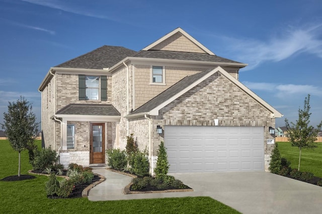 craftsman-style house featuring a garage and a front yard