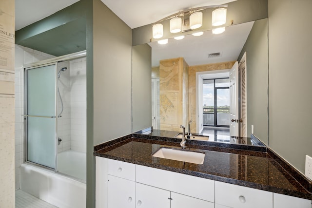 bathroom with vanity and shower / bath combination with glass door