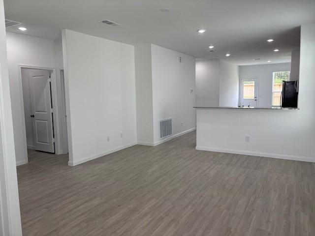 23506 Daisy Grubber Ln, Hockley, TX 77447 - empty room featuring wood finished floors, recessed lighting, and baseboards