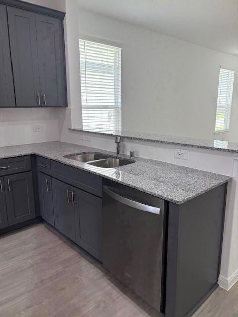 23506 Daisy Grubber Ln, Hockley, TX 77447 - kitchen with dishwasher, light wood finished floors, a sink, and plenty of natural light