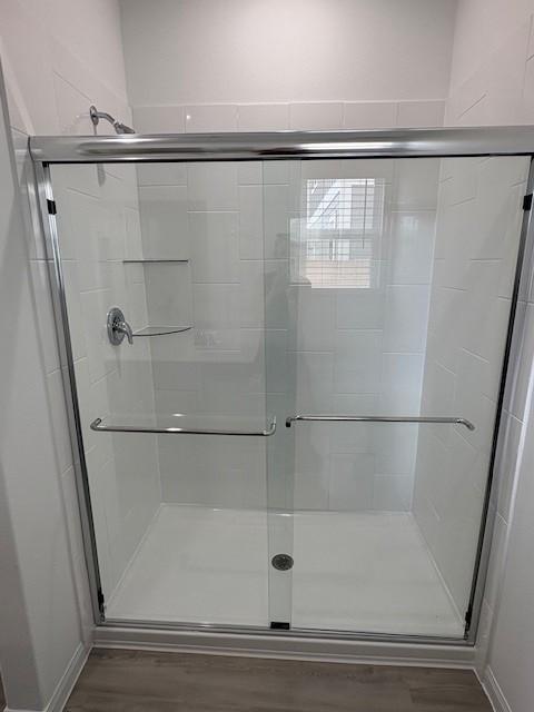 23506 Daisy Grubber Ln, Hockley, TX 77447 - bathroom with a shower stall and wood finished floors