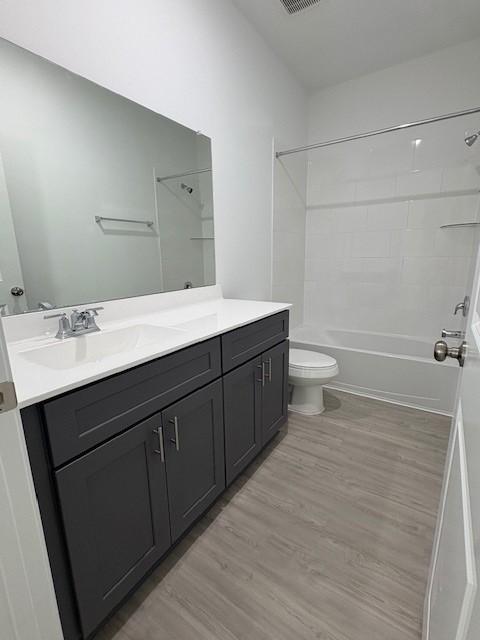 23506 Daisy Grubber Ln, Hockley, TX 77447 - bathroom with vanity, toilet, washtub / shower combination, and wood finished floors