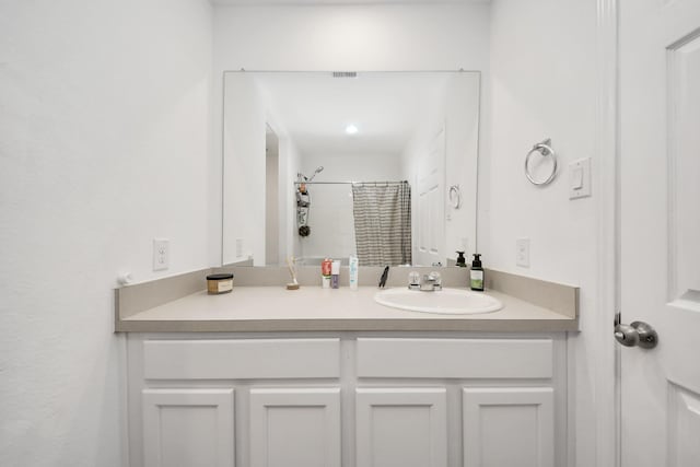 bathroom with vanity and walk in shower