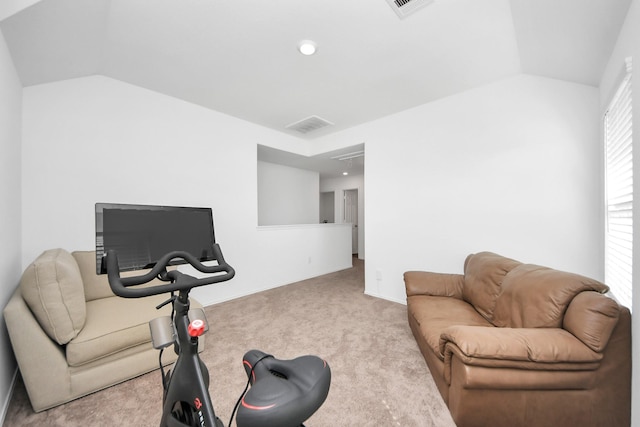 workout room with vaulted ceiling and light colored carpet