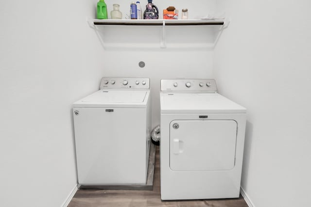 washroom featuring washing machine and dryer and hardwood / wood-style floors