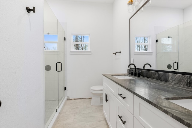 bathroom with vanity, toilet, and an enclosed shower