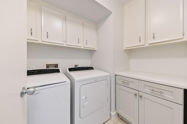 washroom with cabinets and washing machine and dryer