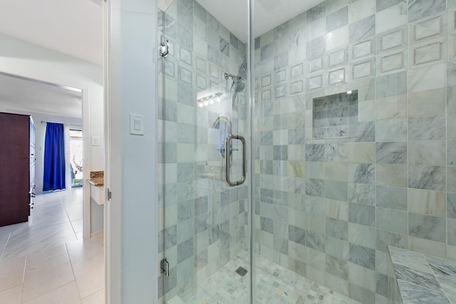 bathroom with tile patterned flooring and a shower with shower door