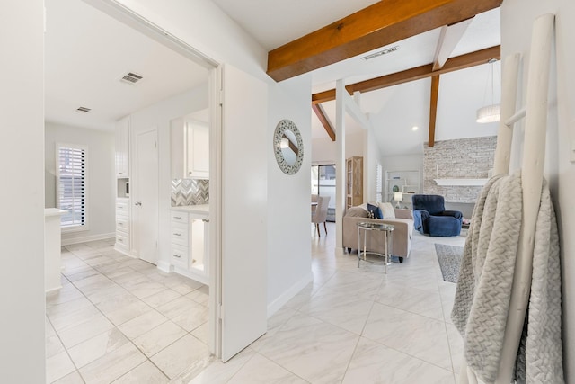 corridor featuring vaulted ceiling with beams