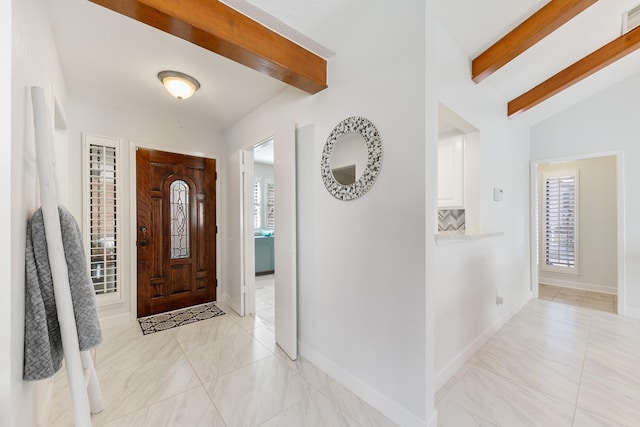 foyer featuring lofted ceiling with beams