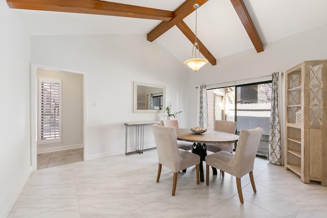 dining room with beamed ceiling and high vaulted ceiling